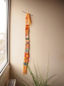backstrap weave hanging by window